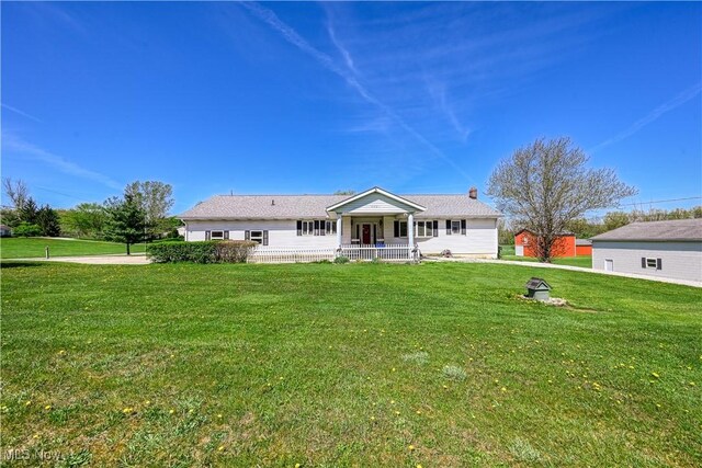4561 Industry Rd, Ravenna, OH 44266 - rear view of house featuring covered porch and a yard