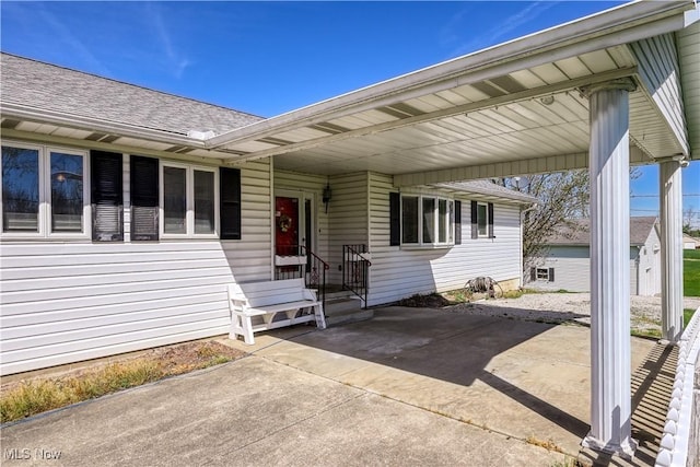 4561 Industry Rd, Ravenna, OH 44266 - property entrance featuring a shingled roof and a carport