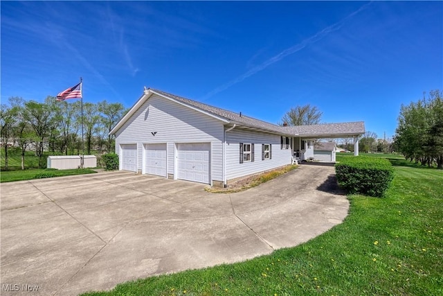4561 Industry Rd, Ravenna, OH 44266 - view of property exterior with a garage, a yard, and driveway