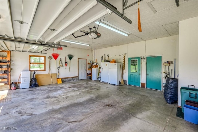 4561 Industry Rd, Ravenna, OH 44266 - garage featuring a garage door opener and freestanding refrigerator