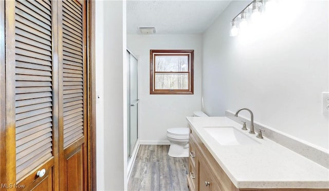 full bathroom featuring a shower stall, a closet, and toilet