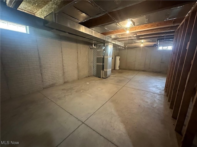 basement featuring heating unit and water heater