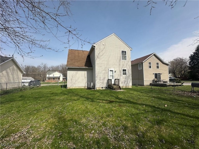 back of house featuring a lawn, fence, entry steps, and cooling unit