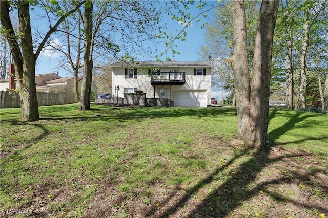 back of house with a yard, a deck, and fence