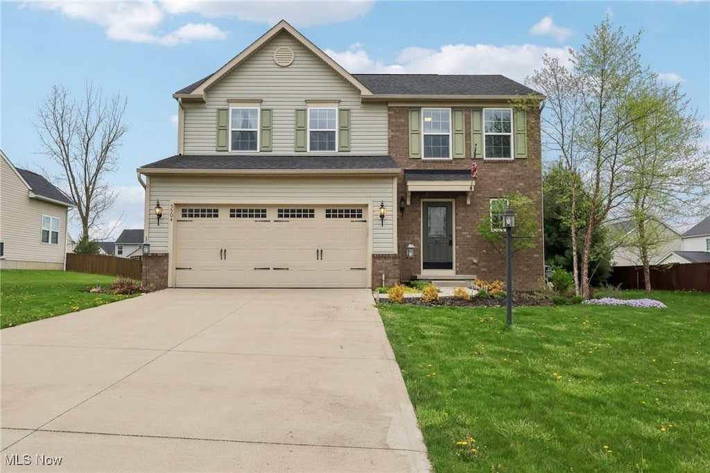 5504 Wightman Cir, Medina, OH 44256 - view of front of home featuring a garage, brick siding, and concrete driveway