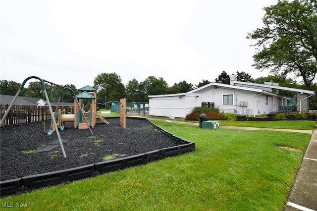 view of playground with a yard and fence