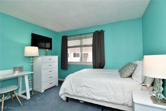 carpeted bedroom featuring baseboards
