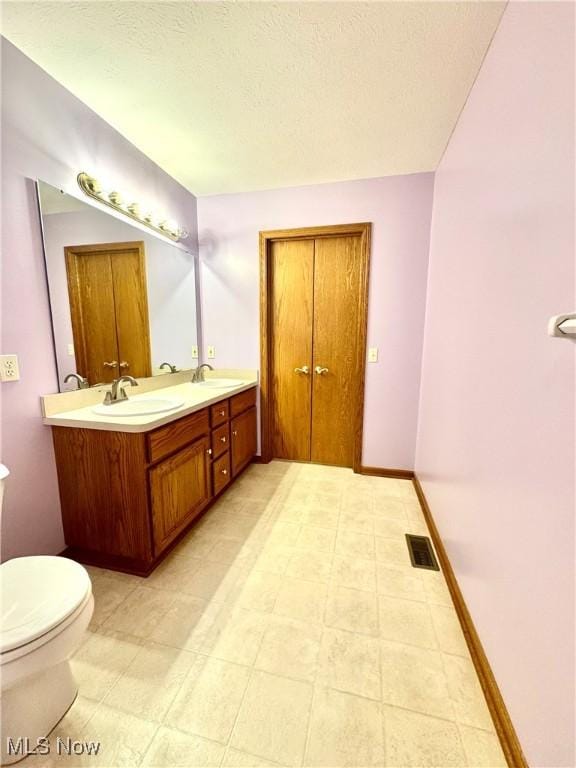 2457 Barrington Way Unit 316, Wooster, OH 44691 - bathroom with a sink, toilet, double vanity, and visible vents