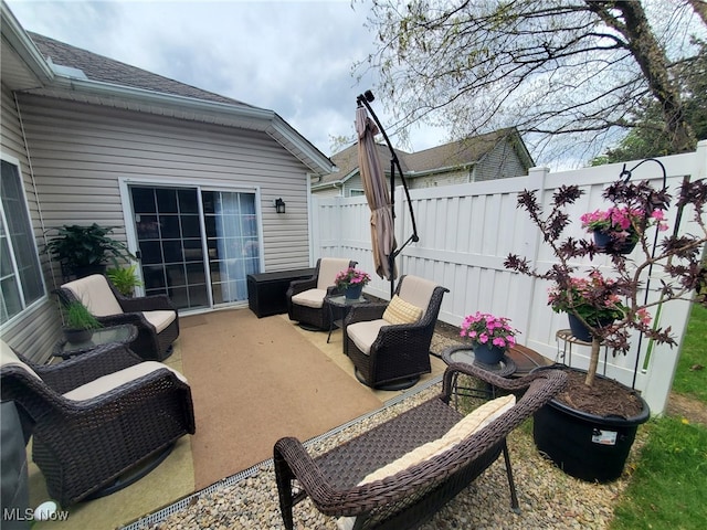 view of patio featuring fence and outdoor lounge area