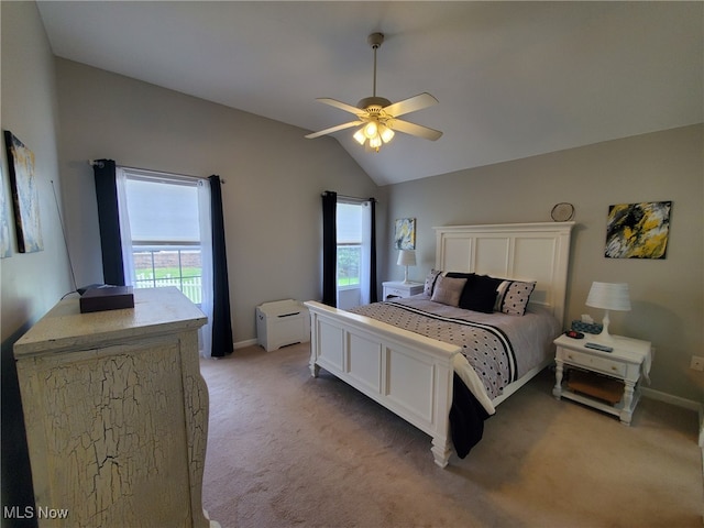 bedroom with light colored carpet, a ceiling fan, vaulted ceiling, and baseboards