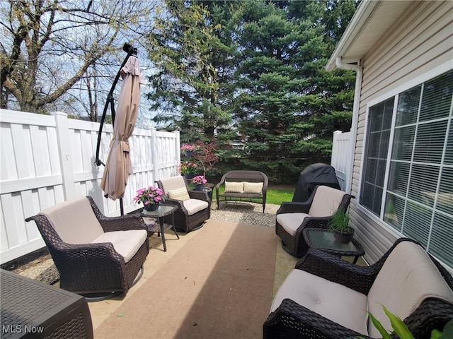 view of patio / terrace with fence and an outdoor living space
