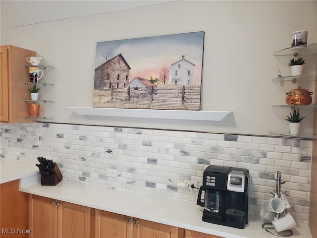 interior space featuring light countertops, open shelves, and backsplash