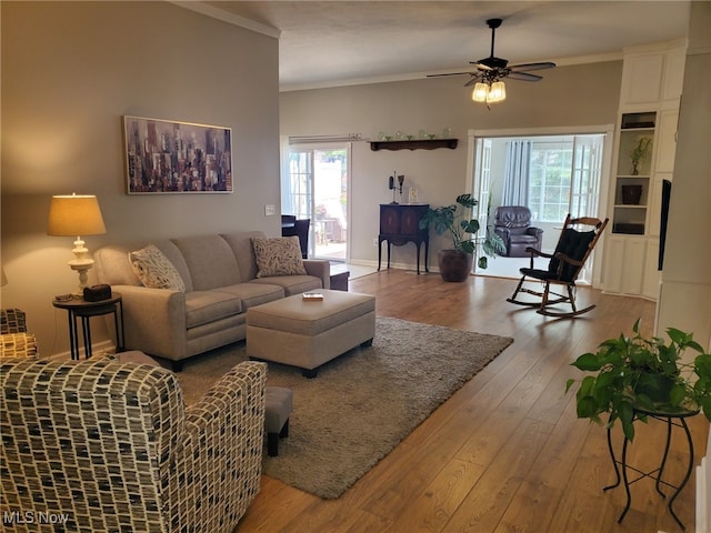 living area with ornamental molding, ceiling fan, and hardwood / wood-style flooring