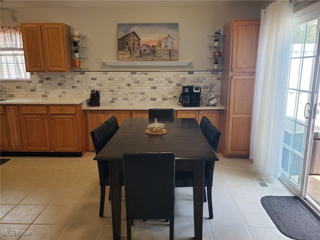 dining area with light tile patterned floors and visible vents