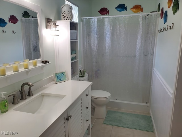 full bathroom with vanity, tile patterned floors, a stall shower, and toilet