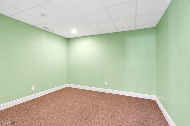 carpeted empty room featuring visible vents, recessed lighting, baseboards, and a drop ceiling