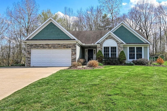 craftsman-style home with a shingled roof, an attached garage, a front lawn, stone siding, and driveway