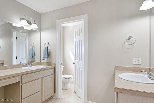 bathroom featuring vanity, tile patterned floors, and toilet