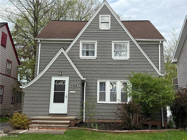 view of front of property with entry steps and roof with shingles