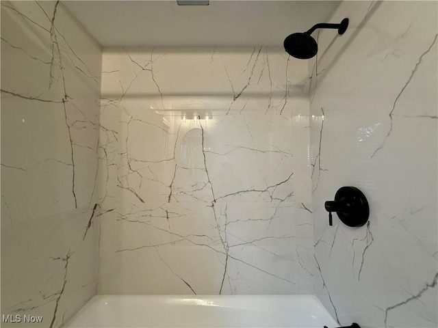 full bath with a marble finish shower
