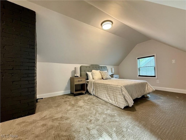 bedroom with baseboards, carpet, and lofted ceiling