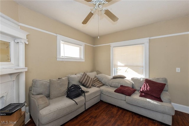 1459 W 107th St, Cleveland, OH 44102 - living room featuring dark wood-type flooring, a ceiling fan, baseboards, and a fireplace
