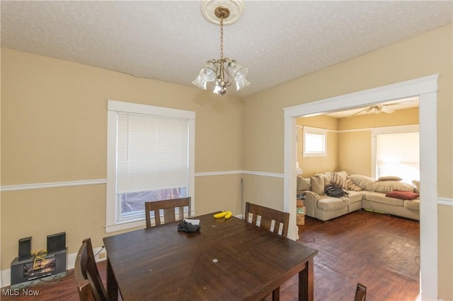 1459 W 107th St, Cleveland, OH 44102 - dining area with an inviting chandelier, a textured ceiling, and wood finished floors
