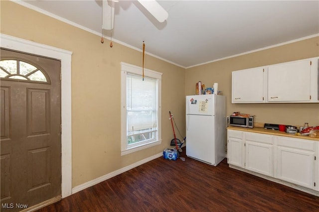 1459 W 107th St, Cleveland, OH 44102 - kitchen featuring white cabinets, freestanding refrigerator, stainless steel microwave, baseboards, and dark wood-style floors