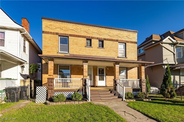 1459 W 107th St, Cleveland, OH 44102 - view of front of home with brick siding, covered porch, and a front yard