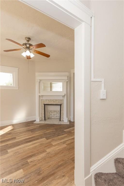 1459 W 107th St, Cleveland, OH 44102 - unfurnished living room featuring a ceiling fan, baseboards, wood finished floors, and a tile fireplace