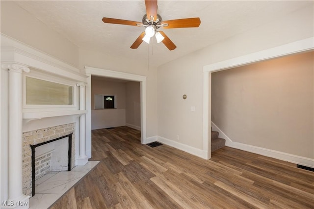 1459 W 107th St, Cleveland, OH 44102 - unfurnished living room with visible vents, stairs, wood finished floors, a fireplace, and baseboards