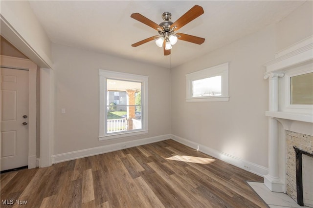1459 W 107th St, Cleveland, OH 44102 - unfurnished living room with baseboards, ceiling fan, wood finished floors, and a fireplace