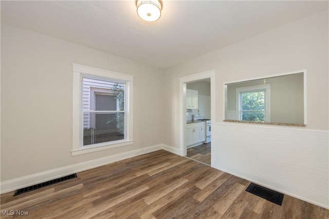 1459 W 107th St, Cleveland, OH 44102 - empty room featuring baseboards, visible vents, and wood finished floors