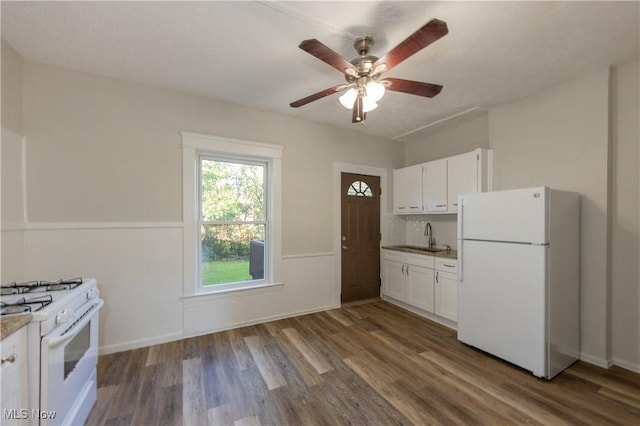 1459 W 107th St, Cleveland, OH 44102 - kitchen with white cabinets, dark wood-style flooring, light stone countertops, ceiling fan, and white appliances