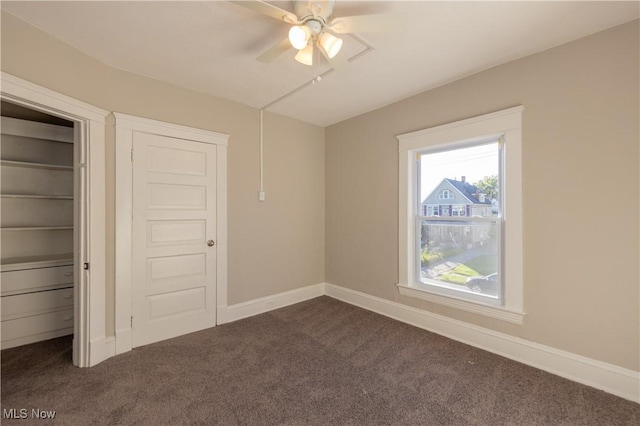 1459 W 107th St, Cleveland, OH 44102 - unfurnished bedroom featuring dark colored carpet, a ceiling fan, and baseboards