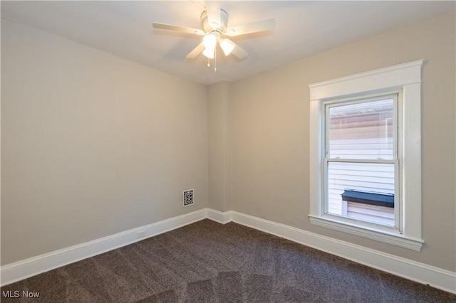 1459 W 107th St, Cleveland, OH 44102 - unfurnished room with a ceiling fan, baseboards, visible vents, and dark carpet