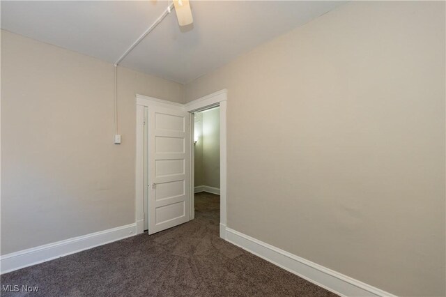 1459 W 107th St, Cleveland, OH 44102 - empty room featuring baseboards and dark colored carpet