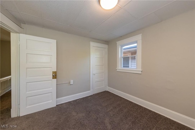 1459 W 107th St, Cleveland, OH 44102 - spare room featuring baseboards and dark carpet