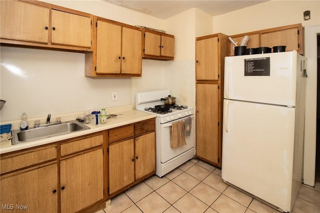 kitchen featuring a sink, light tile patterned flooring, white appliances, and light countertops