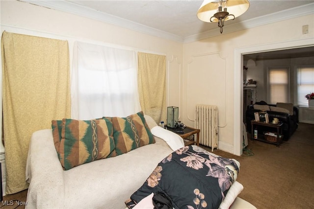 bedroom with carpet floors, ornamental molding, and radiator