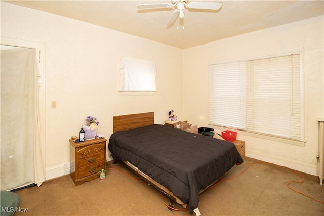 carpeted bedroom with baseboards and ceiling fan