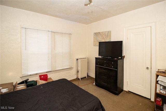 bedroom with radiator, a ceiling fan, and carpet flooring