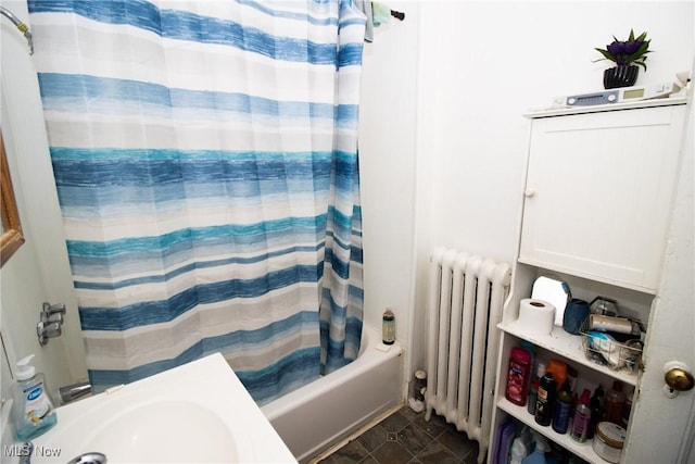 full bath with radiator, tile patterned floors, and shower / tub combo