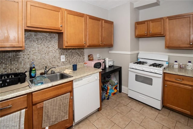 kitchen with light tile patterned flooring, white appliances, light countertops, a sink, and backsplash