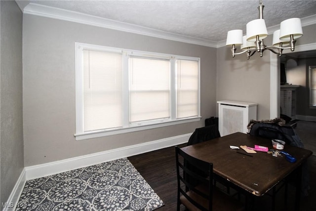 office space featuring a textured ceiling, crown molding, wood finished floors, baseboards, and a chandelier