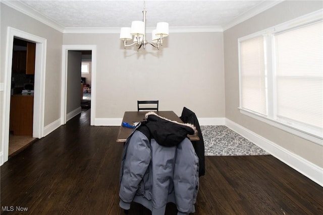 dining space with crown molding, baseboards, a chandelier, and wood finished floors