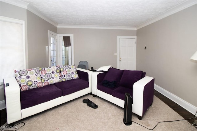 living area featuring a textured ceiling, baseboards, ornamental molding, and wood finished floors
