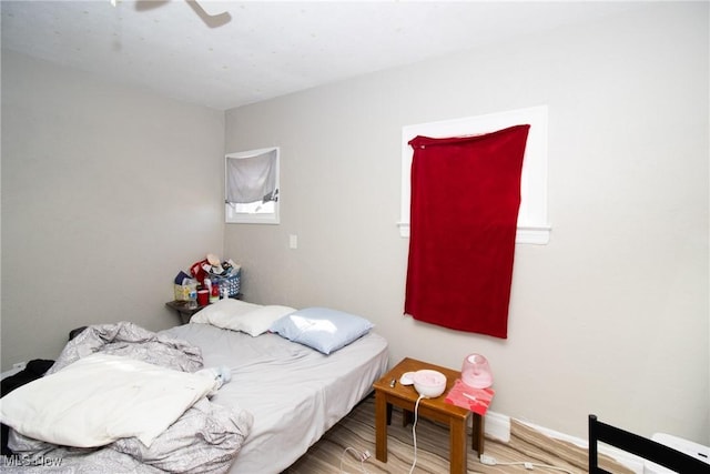 bedroom with ceiling fan and wood finished floors