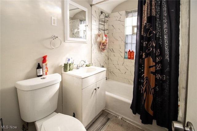 bathroom featuring vanity, shower / bath combo with shower curtain, and toilet