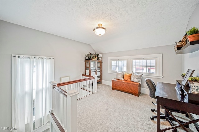 office with baseboards, a textured ceiling, carpet, and lofted ceiling